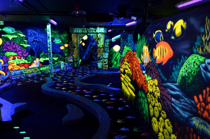 UV lit 4D mini golf course with glowing obstacles